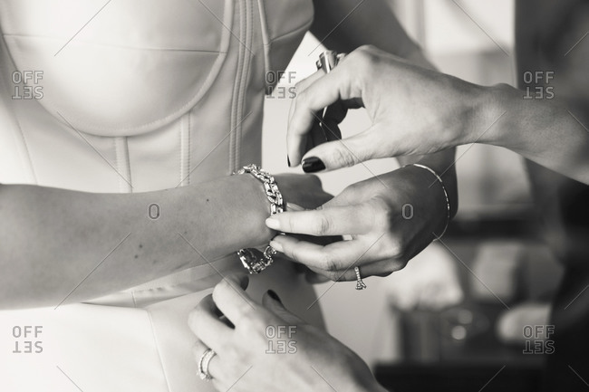 Bride putting on a diamond bracelet