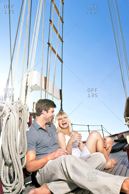 Happy young couple on a sailing ship