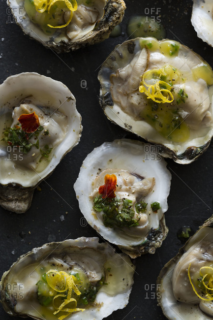 Roasted oysters topped with melted butter and lemon zest.