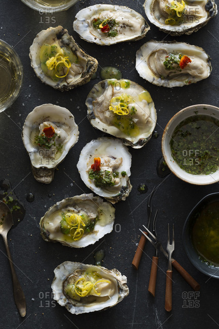 Roasted oysters served with herbed butter and lemon zest