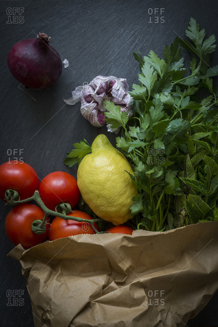 Various herbs and veggies in paper bag