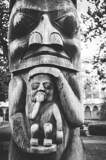 A carved wooden totem pole in Victoria, Canada