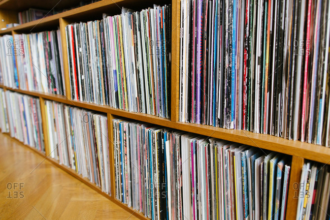 A record collection on a wooden shelf