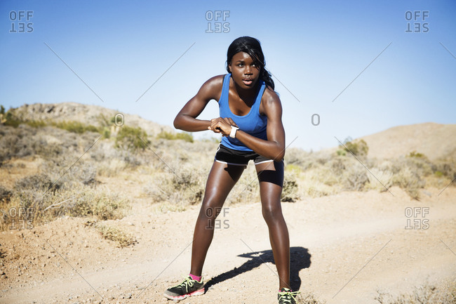 Athletic woman in remote setting ready for a run
