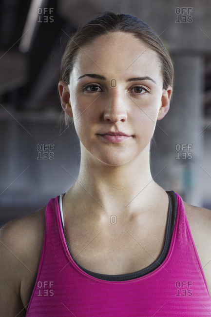 Portrait of woman athlete in industrial setting