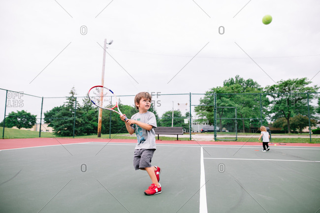 Boy playing a game of tennis