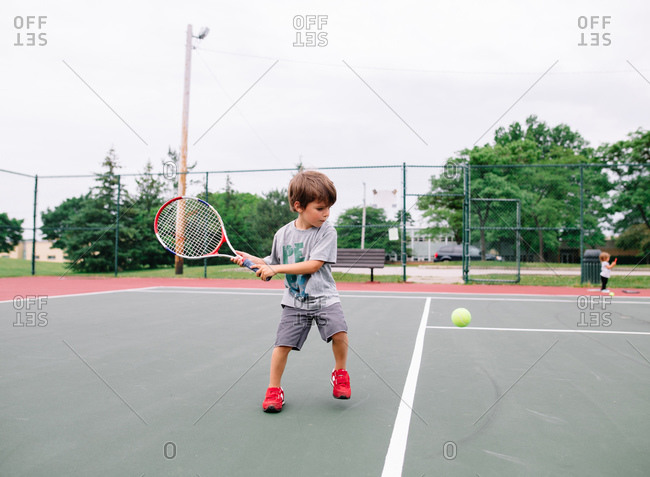 Boy practicing his tennis swing