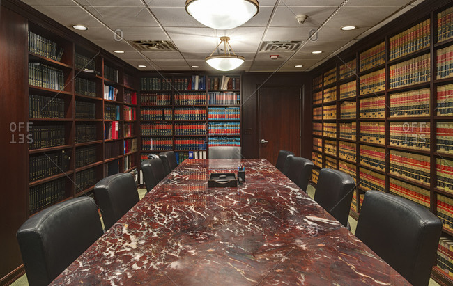 Inside a law library conference room with long marble table