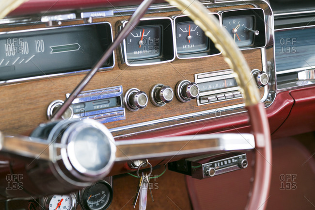 The wood paneled dashboard of a vintage car