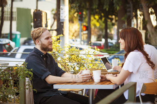 Couple having coffee at an outdoor cafe