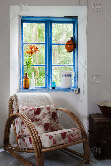 A bamboo chair in the corner of a country home