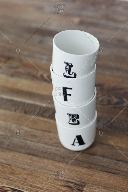 A stack of mugs with letters on them in a Swedish kitchen