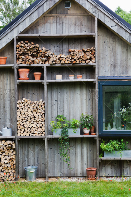 A countryside home stocked with chopped wood in Sweden