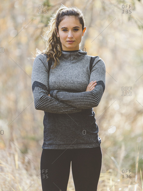 Woman in athletic clothing with arms crossed