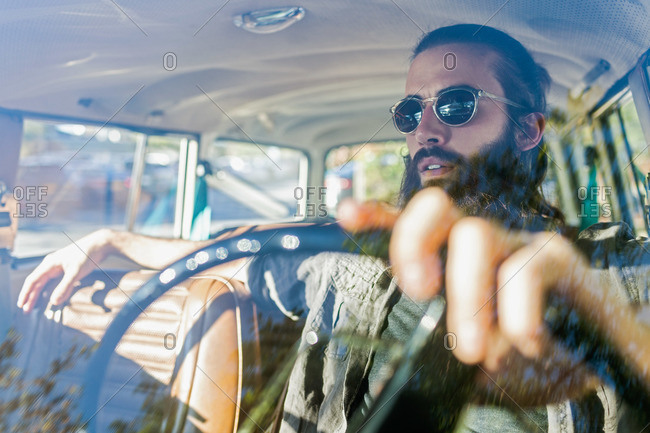 View through windshield of bearded man in vintage car