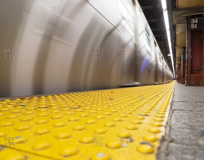 A subway train moves at a New York City station