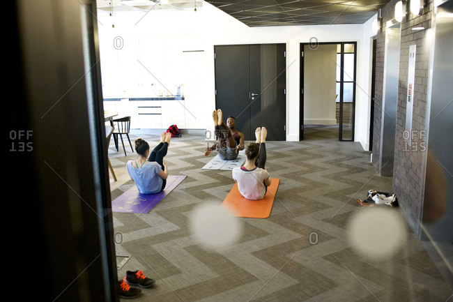 Employees doing yoga in office