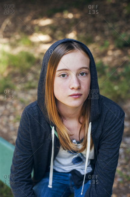 A pre-teen girl in a hooded shirt