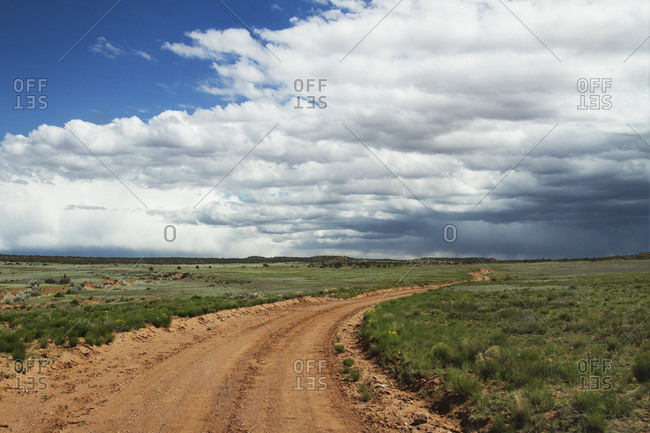 Dirt road and changing weather over a Texas landscape