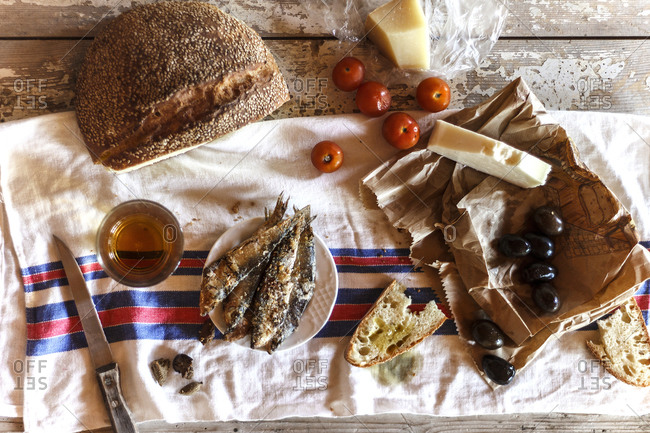 A Sicilian meal with bread, fish, and cheese