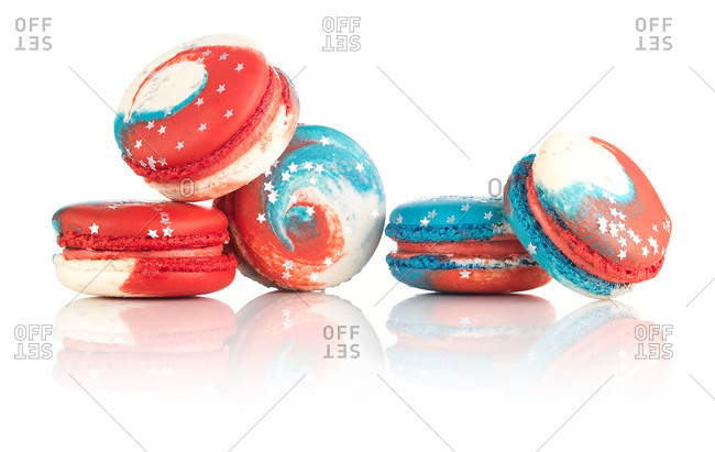 Five patriotic macaron cookies with edible silver stars on white background