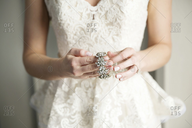 A bride puts on a bracelet