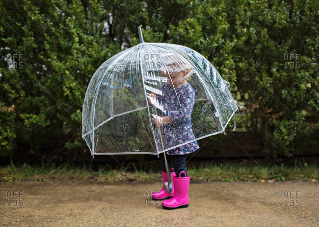 Little girl holding a clear umbrella