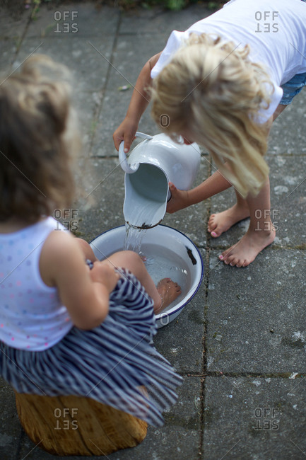 Girl pouring water from porcelain jar