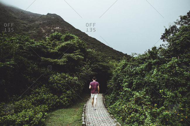 A man walks along a stone path at Tai Long Wan in Hong Kong