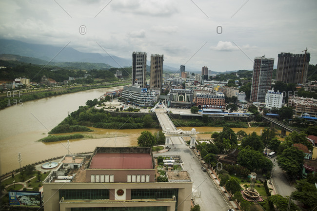 A cityscape of Lao Cai, Vietnam, with a view towards the pedestrian crossing and Hekou, China, on the other side of the border