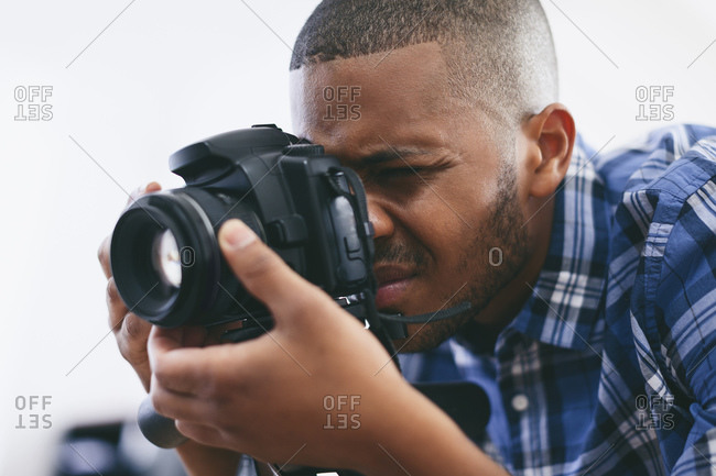 Young man at work in his photographic studio