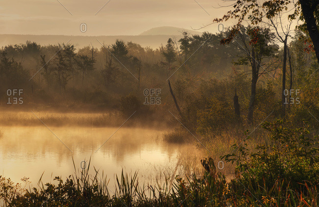 Mist over the water at sunrise in Foster, Quebec, Canada