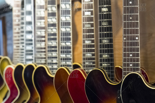 Guitars for sale hanging in row