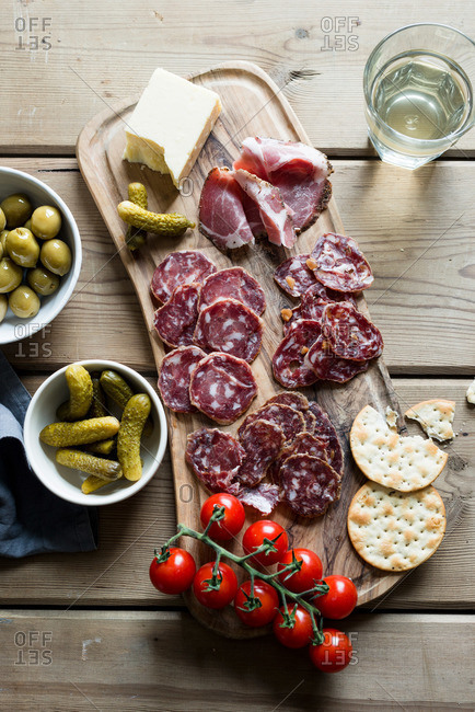 Charcuterie with pickles, olives, cheese, and tomatoes
