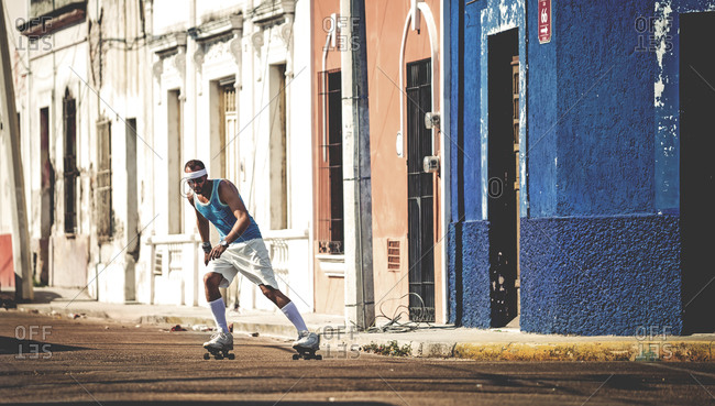 Man skating down an empty city street