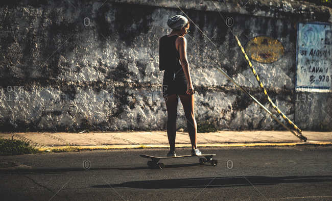 Woman on a skateboard on an empty city street
