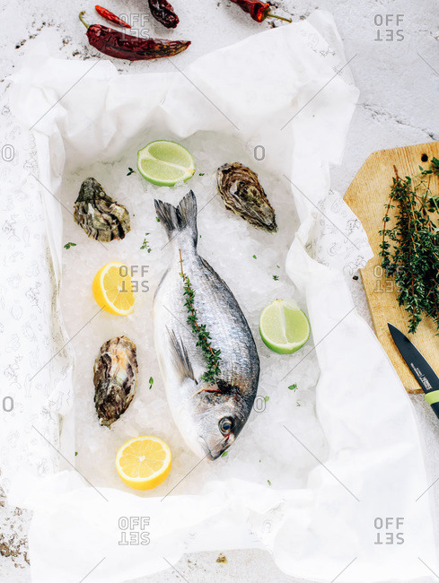Whole fish with herbs, citrus and oysters