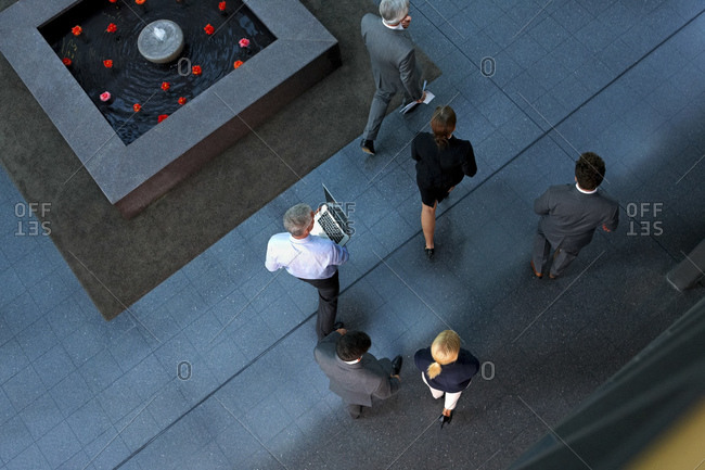 Top view of businesspeople walking through lobby