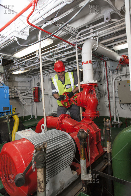 Man working in engine room on a ship