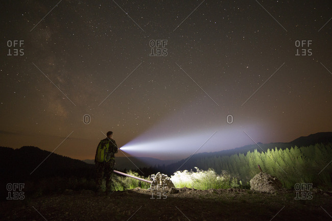 A man hikes at night