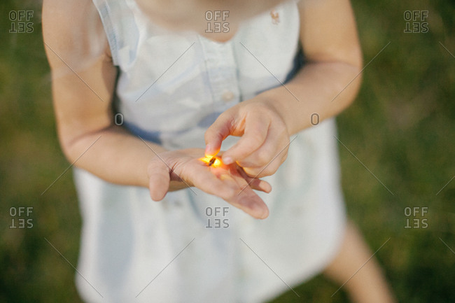 Child holding a firefly