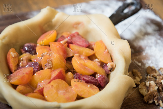 Plums in an uncooked pie shell