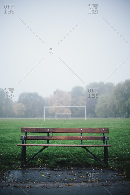 Bench and a soccer goal in the rain at Victoria Park in London