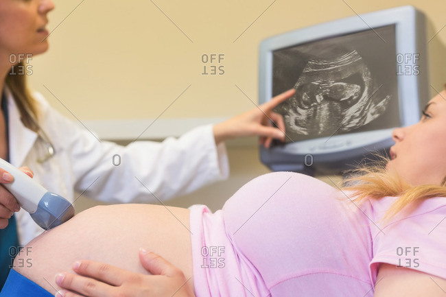 Doctor showing ultrasound scan to her patient at the ultrasound clinic