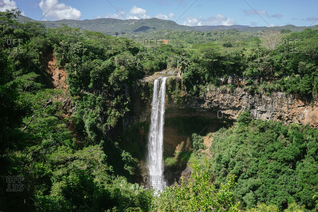 Waterfall on a green mountainside in the Republic of Mauritius