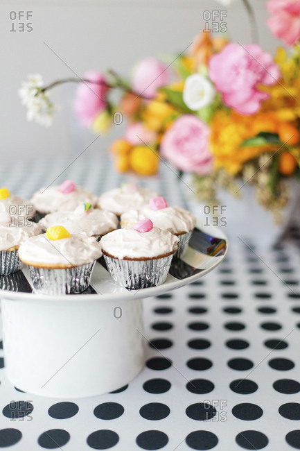 Cupcakes and flowers on polka dotted table