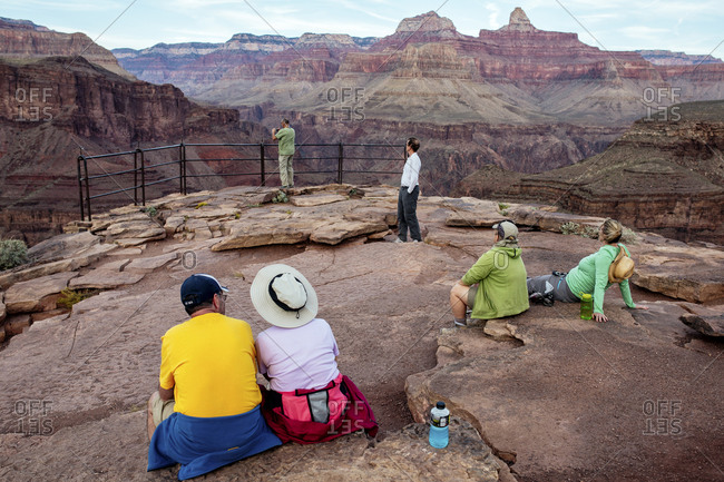 Tourists sitting at overlook in the Grand Canyon
