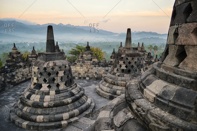 Bell-shaped stupa surround the central dome at Borobudur, a Mahayana Buddhist temple in Java at dawn