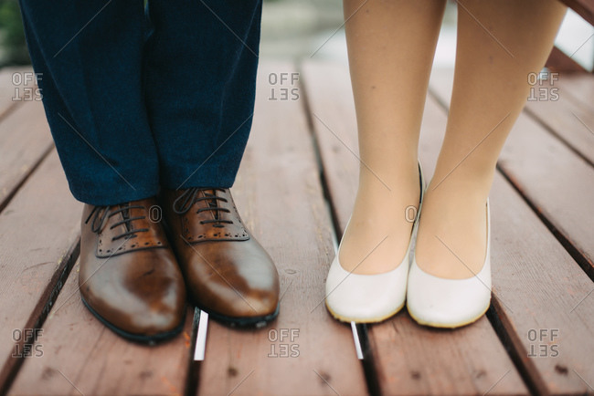 Bride and grooms\' feet standing on deck