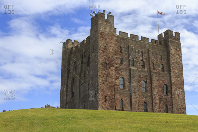 Bamburgh Castle, The Keep, with English flag of St George, Bamburgh, Northumberland, England, United Kingdom